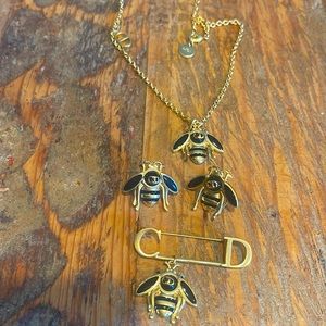 Black and gold bee necklace, earrings and brooch. Gold plated material.
